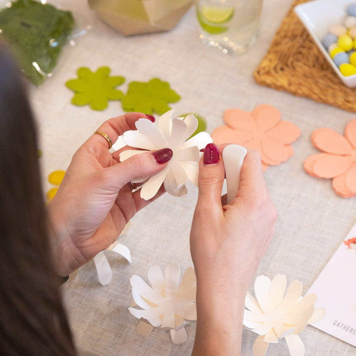 Person crafting paper flowers from an all inclusive craft kit