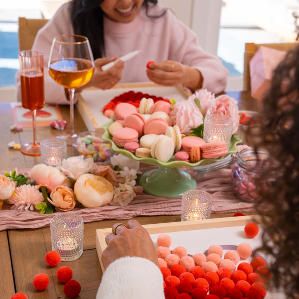 women crafting together while enjoying treats and drinks