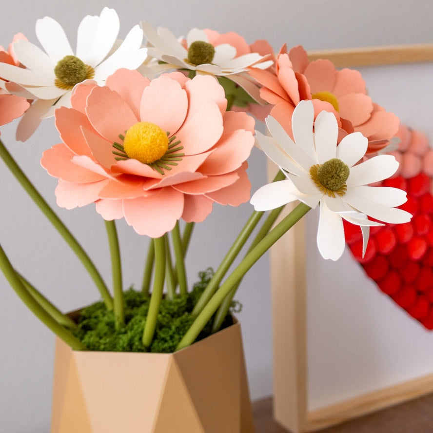 Paper flowers in a vase with moss