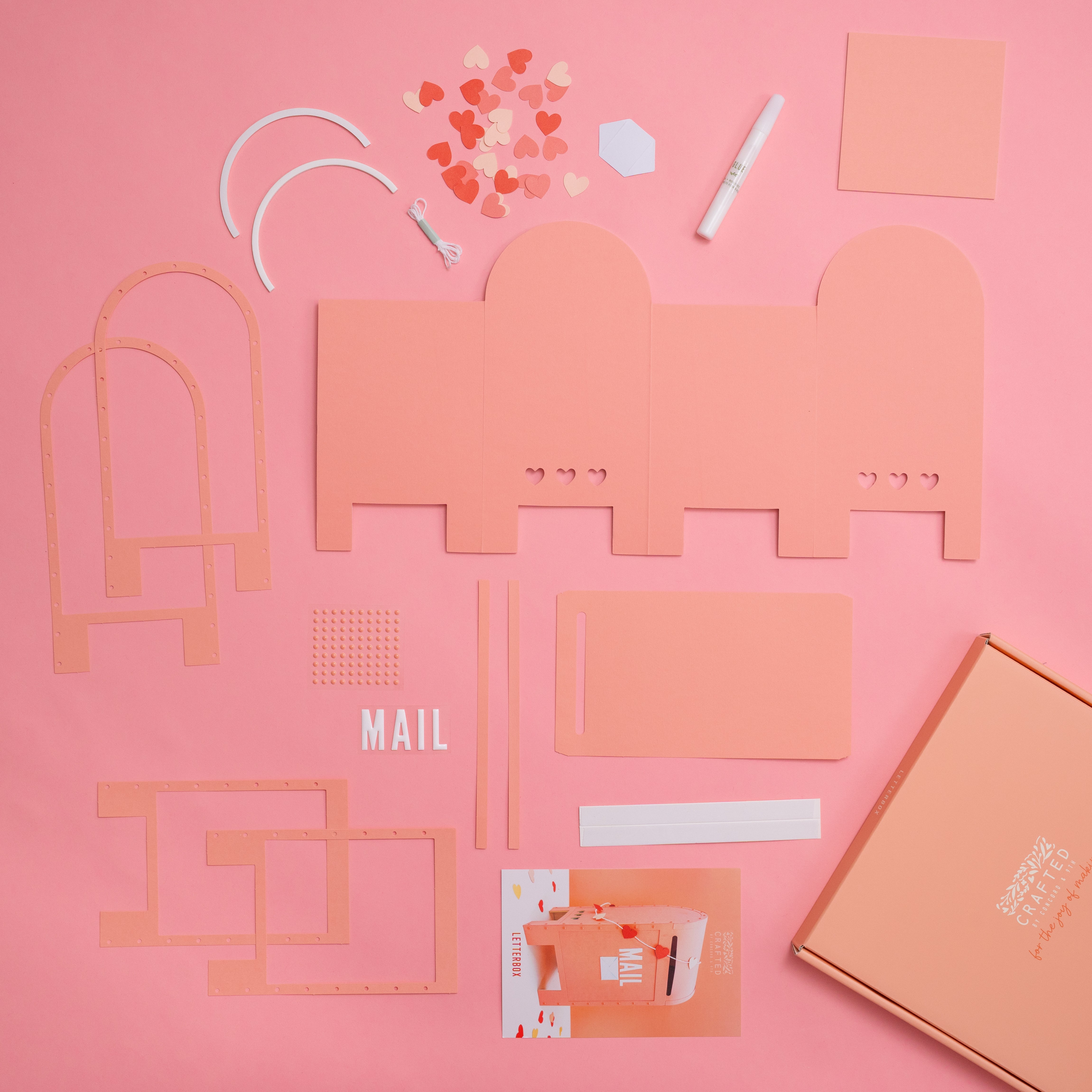 Collection of craft kit contents for Letterbox on a pink background